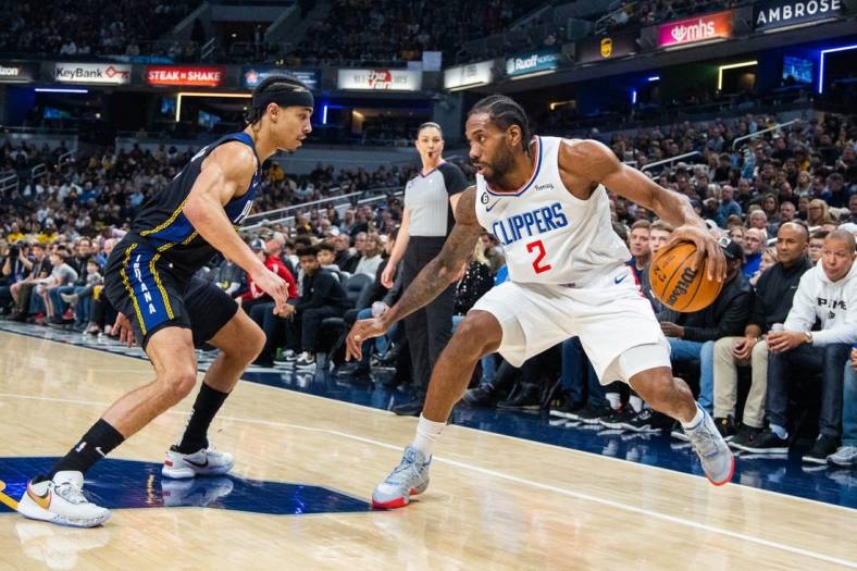 Dec 31, 2022; Indianapolis, Indiana, USA; LA Clippers forward Kawhi Leonard (2) dribbles the ball while Indiana Pacers guard Andrew Nembhard (2) defends in the first quarter at Gainbridge Fieldhouse. Mandatory Credit: Trevor Ruszkowski-USA TODAY Sports