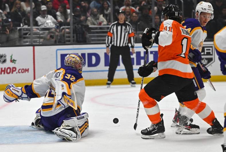 Dec 31, 2022; Los Angeles, California, USA;  Los Angeles Kings goaltender Jonathan Quick (32) makes a save off a shot by Philadelphia Flyers right wing Travis Konecny (11) in the first period of the game at Crypto.com Arena. Mandatory Credit: Jayne Kamin-Oncea-USA TODAY Sports