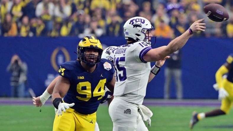 Dec 31, 2022; Glendale, Arizona, USA; TCU Horned Frogs quarterback Max Duggan (15) passes against Michigan Wolverines defensive lineman Kris Jenkins (94) in the second quarter of the 2022 Fiesta Bowl at State Farm Stadium. Mandatory Credit: Matt Kartozian-USA TODAY Sports