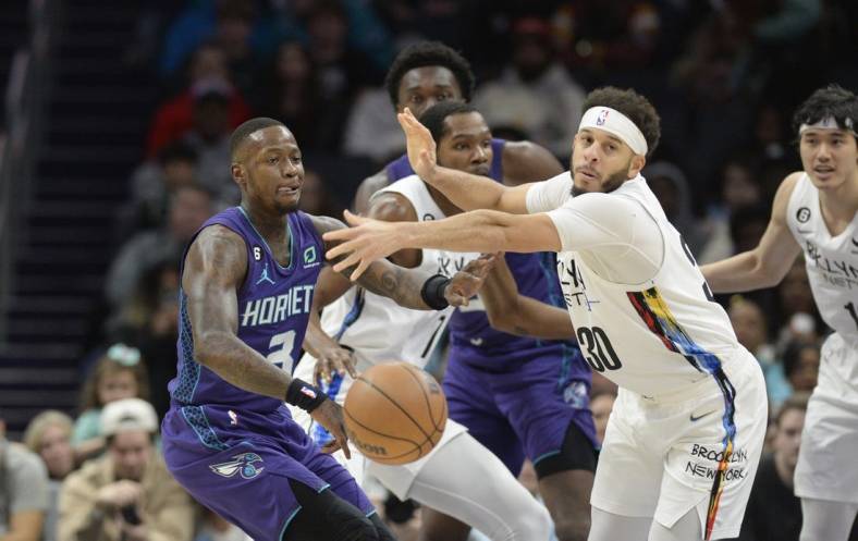 Dec 31, 2022; Charlotte, North Carolina, USA; Brooklyn Nets guard Seth Curry (30) loses the ball against Charlotte Hornets guard Terry Rozier (3) during the first half at the Spectrum Center. Mandatory Credit: Sam Sharpe-USA TODAY Sports