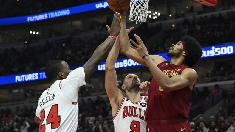 Dec 31, 2022; Chicago, Illinois, USA;  Chicago Bulls forward Javonte Green (24) and Chicago Bulls center Nikola Vucevic (9) fight for a rebound against Cleveland Cavaliers center Jarrett Allen (31) during the first half at United Center. Mandatory Credit: Matt Marton-USA TODAY Sports