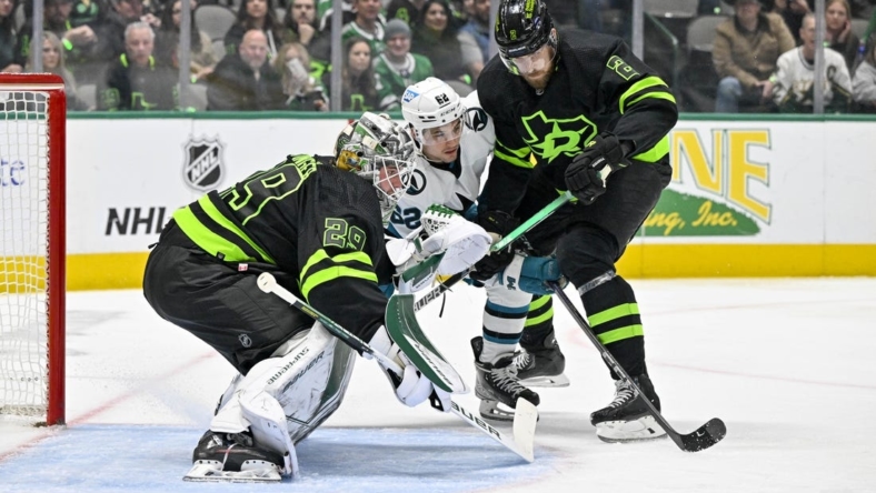 Dec 31, 2022; Dallas, Texas, USA; San Jose Sharks right wing Kevin Labanc (62) looks for the puck as Dallas Stars goaltender Jake Oettinger (29) and defenseman Jani Hakanp   (2) defend the goal during the first period at the American Airlines Center. Mandatory Credit: Jerome Miron-USA TODAY Sports