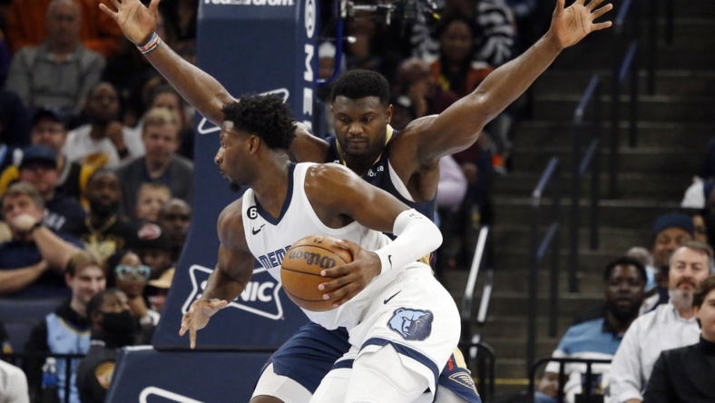 Dec 31, 2022; Memphis, Tennessee, USA; Memphis Grizzlies forward Jaren Jackson Jr. (13) controls the ball against New Orleans Pelicans forward Zion Williamson (1) during the first half at FedExForum. Mandatory Credit: Petre Thomas-USA TODAY Sports