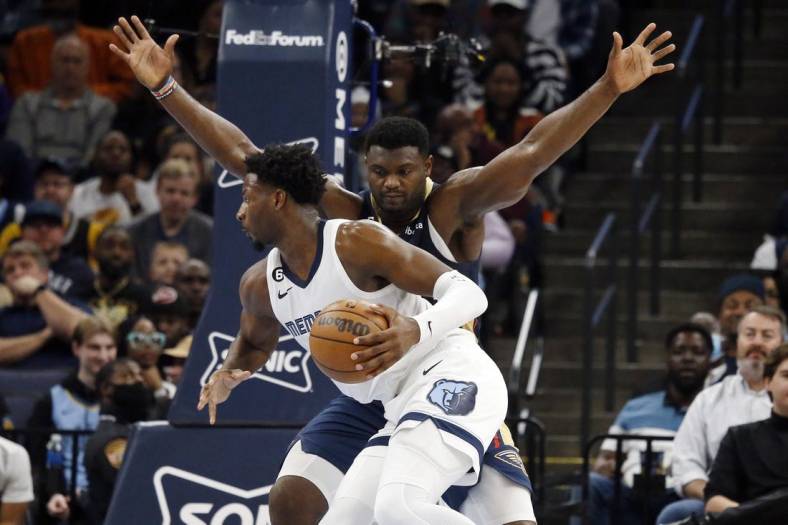 Dec 31, 2022; Memphis, Tennessee, USA; Memphis Grizzlies forward Jaren Jackson Jr. (13) controls the ball against New Orleans Pelicans forward Zion Williamson (1) during the first half at FedExForum. Mandatory Credit: Petre Thomas-USA TODAY Sports