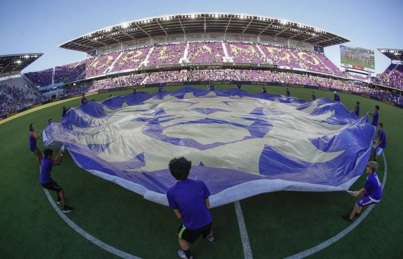 May 24, 2019; Orlando, FL, USA; Orlando City SC fan kids wave the team logo banner at mid field before a match against the Los Angeles Galaxy  at Orlando City Stadium. Mandatory Credit: Reinhold Matay-USA TODAY Sports