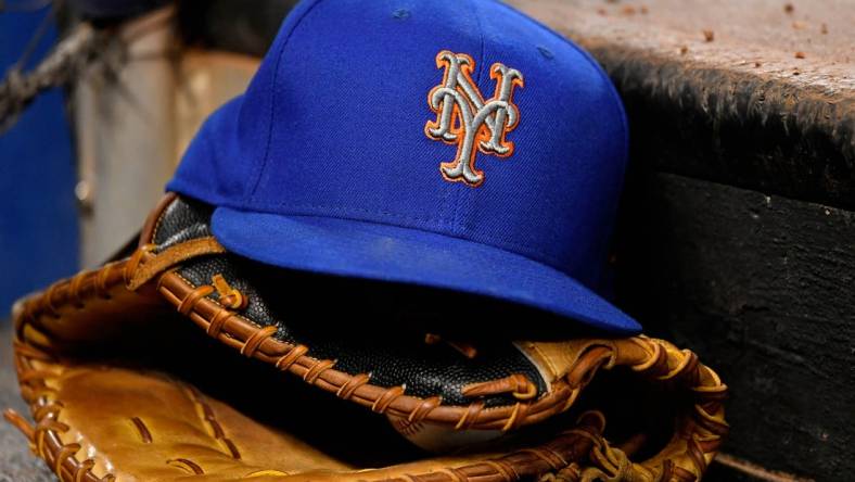 Jul 13, 2019; Miami, FL, USA; A general view of a New York Mets hat and glove on the steps of the dugout in the game between the Miami Marlins and the New York Mets at Marlins Park. Mandatory Credit: Jasen Vinlove-USA TODAY Sports