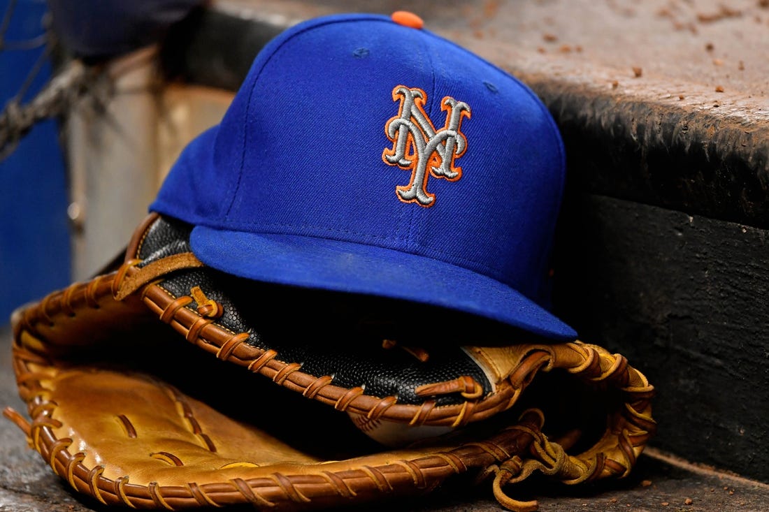 Jul 13, 2019; Miami, FL, USA; A general view of a New York Mets hat and glove on the steps of the dugout in the game between the Miami Marlins and the New York Mets at Marlins Park. Mandatory Credit: Jasen Vinlove-USA TODAY Sports