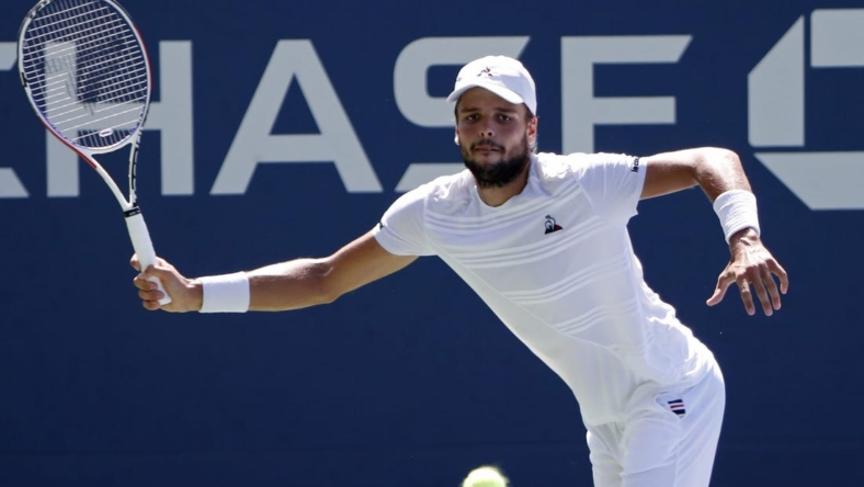 Aug 29, 2019; Flushing, NY, USA; Gregoire Barrere of France hits a forehand against David Goffin of Belgium (not pictured) in the second round on day four of the 2019 U.S. Open tennis tournament at USTA Billie Jean King National Tennis Center. Mandatory Credit: Geoff Burke-USA TODAY Sports