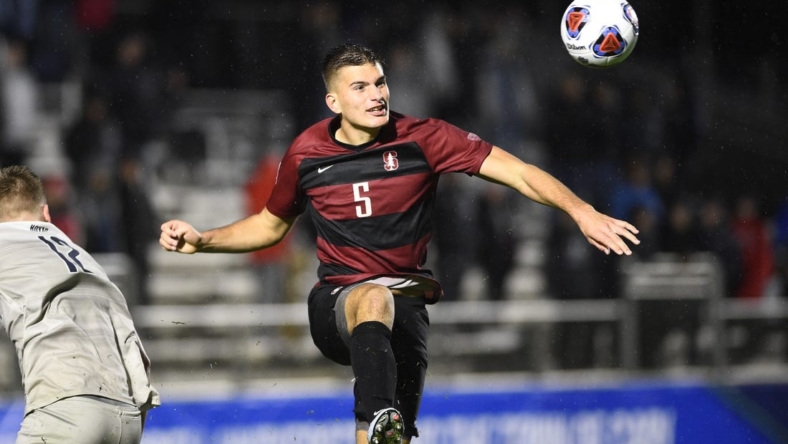 Dec 13, 2019; Cary, NC, USA; Stanford Cardinal defender Keegan Hughes (5) heads the ball in the second half at WakeMed Soccer Park. Mandatory Credit: Bob Donnan-USA TODAY Sports