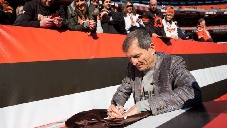 Dec 22, 2019; Cleveland, Ohio, USA; Former Cleveland Browns quarterback Bernie Kosar signs an autograph before the game between the Cleveland Browns and the Baltimore Ravens at FirstEnergy Stadium. Mandatory Credit: Ken Blaze-USA TODAY Sports