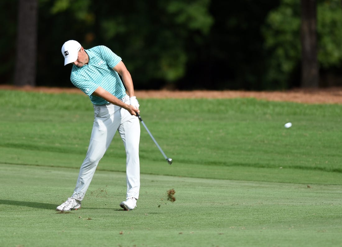 Aug 14, 2020; Greensboro, North Carolina, USA; Jordan Speith hits his approach shot on the eighteenth hole during the second round of the Wyndham Championship golf tournament at Sedgefield Country Club. Mandatory Credit: Rob Kinnan-USA TODAY Sports