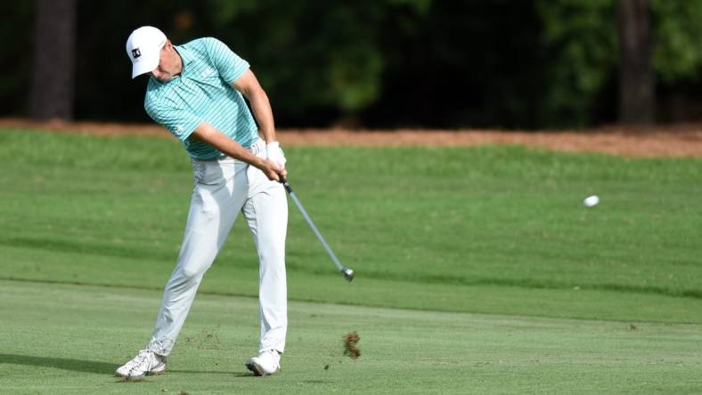 Aug 14, 2020; Greensboro, North Carolina, USA; Jordan Speith hits his approach shot on the eighteenth hole during the second round of the Wyndham Championship golf tournament at Sedgefield Country Club. Mandatory Credit: Rob Kinnan-USA TODAY Sports