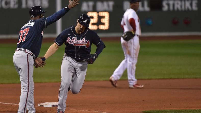 Sep 2, 2020; Boston, Massachusetts, USA;  Atlanta Braves third base coach Ron Washington (37) congratulates right fielder Adam Duvall (23) after hitting a two run home run during the sixth inning against the Boston Red Sox at Fenway Park. Mandatory Credit: Bob DeChiara-USA TODAY Sports