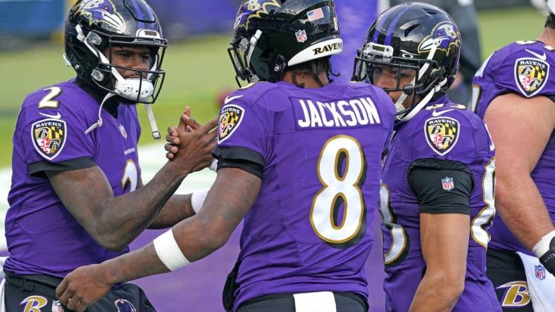 Dec 20, 2020; Baltimore, Maryland, USA; Baltimore Ravens quarterback Lamar Jackson (8) greets quarterback Tyler Huntley (2) prior to a game against the Jacksonville Jaguars at M&T Bank Stadium. Mandatory Credit: Mitch Stringer-USA TODAY Sports