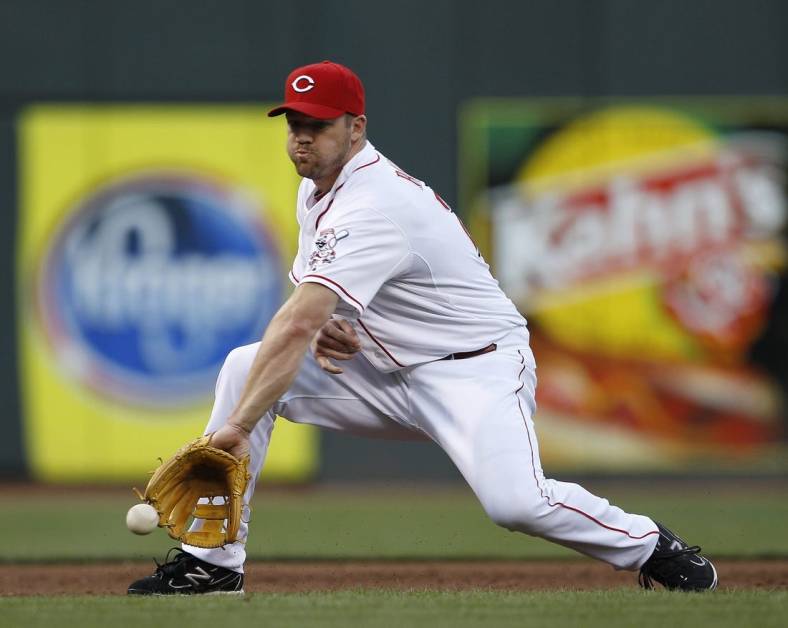 AUGUST 17, 2012: Cincinnati Reds third baseman Scott Rolen (27) makes the grab and the throw to first for the out in the third inning against the Chicago Cubs.

Reds