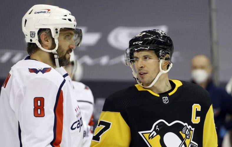 Feb 14, 2021; Pittsburgh, Pennsylvania, USA;  Washington Capitals left wing Alex Ovechkin (8) and Pittsburgh Penguins center Sidney Crosby (87) talk before a face-off during the second period at PPG Paints Arena. Mandatory Credit: Charles LeClaire-USA TODAY Sports
