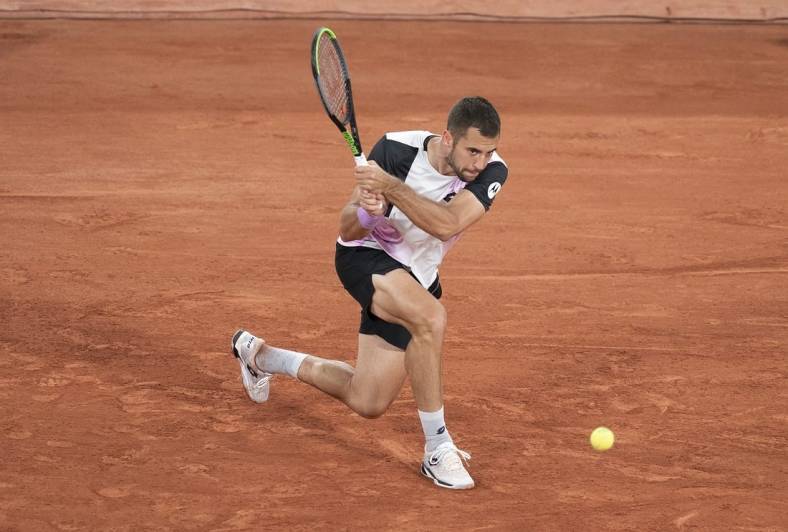 Jun 4, 2021; Paris, France;  Laslo Djere (SRB) in action during his match against Alexander Zverev (GER) on day six of the French Open at Stade Roland Garros. Mandatory Credit: Susan Mullane-USA TODAY Sports