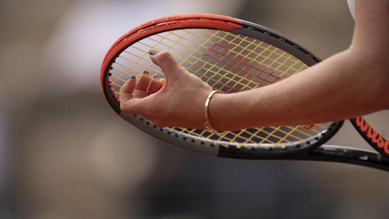 Jun 8, 2021; Paris, France; Detailed view of Anastasia Pavlyuchenkova's (RUS) fingernails on her racket during her match against Elena Rybakina (KAZ) on day 10 of the French Open at Stade Roland Garros. Mandatory Credit: Susan Mullane-USA TODAY Sports