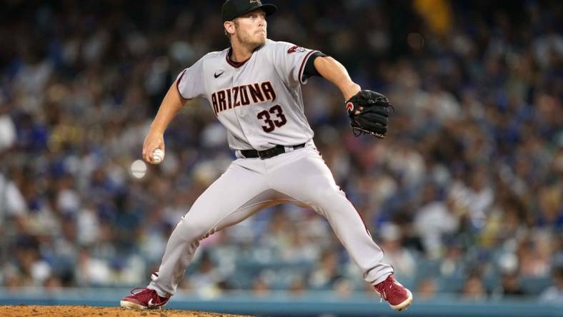 Jul 9, 2021; Los Angeles, California, USA; Arizona Diamondbacks starting pitcher J.B. Bukauskas (33) delivers a pitch against the Los Angeles Dodgers at Dodger Stadium. Mandatory Credit: Kirby Lee-USA TODAY Sports