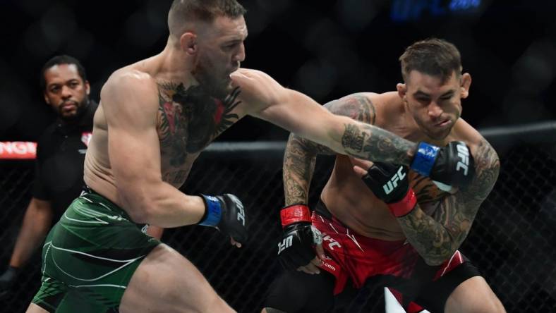 Jul 10, 2021; Las Vegas, Nevada, USA; Conor McGregor moves in for a hit against Dustin Poirier during UFC 264 at T-Mobile Arena. Mandatory Credit: Gary A. Vasquez-USA TODAY Sports