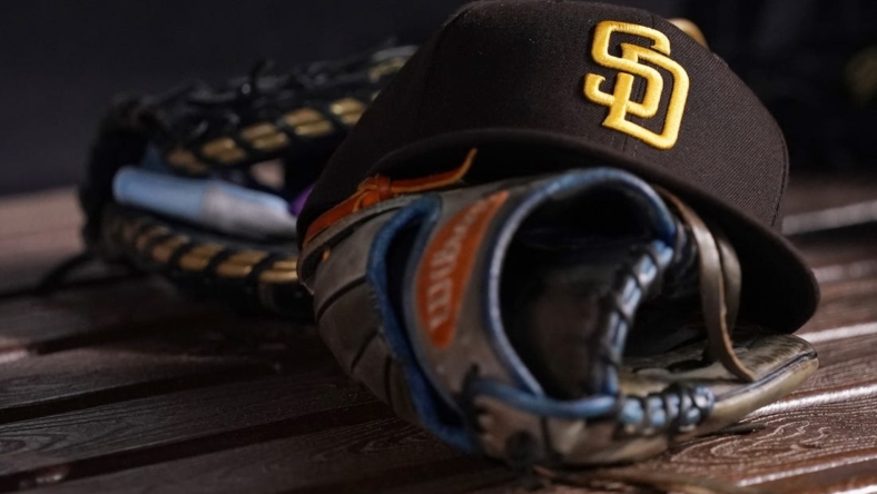 Jul 23, 2021; Miami, Florida, USA; A general view of a San Diego Padres hat and glove in the dugout prior to the game between the Miami Marlins and the San Diego Padres at loanDepot park. Mandatory Credit: Jasen Vinlove-USA TODAY Sports