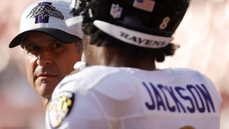 Aug 28, 2021; Landover, Maryland, USA; Baltimore Ravens head coach John Harbaugh (L) talks with Ravens quarterback Lamar Jackson (8) during warmups prior to their game against the Washington Football Team at FedExField. Mandatory Credit: Geoff Burke-USA TODAY Sports