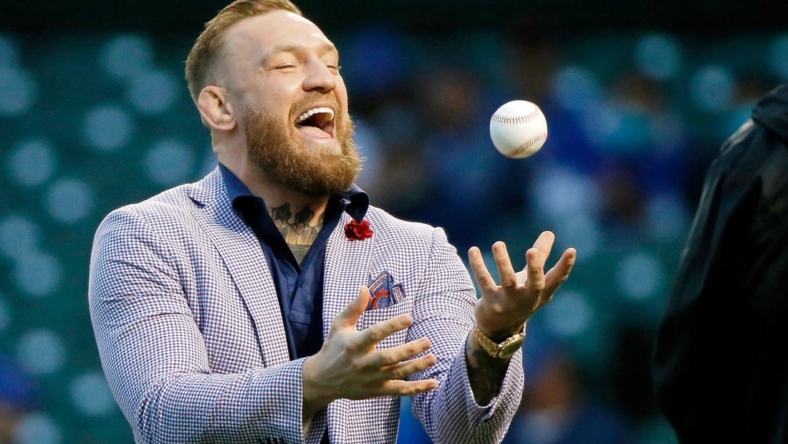 Sep 21, 2021; Chicago, Illinois, USA; MMA fighter Conor McGregor tosses the ball after throwing out a ceremonial first pitch before the game between the Chicago Cubs and the Minnesota Twins at Wrigley Field. Mandatory Credit: Jon Durr-USA TODAY Sports