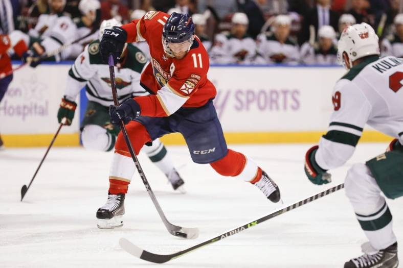 Nov 20, 2021; Sunrise, Florida, USA; Florida Panthers left wing Jonathan Huberdeau (11) shoots the puck against the Minnesota Wild during the third period at FLA Live Arena. Mandatory Credit: Sam Navarro-USA TODAY Sports