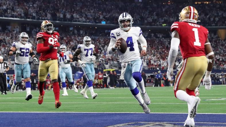 Jan 16, 2022; Arlington, Texas, USA; Dallas Cowboys quarterback Dak Prescott (4) runs for a touchdown against the San Francisco 49ers during the second half of the NFC Wild Card playoff football game at AT&T Stadium. Mandatory Credit: Kevin Jairaj-USA TODAY Sports