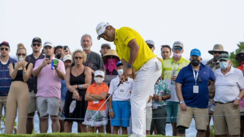 January 16, 2022; Honolulu, Hawaii, USA; Hideki Matsuyama putts on the 17th hole during the final round of the Sony Open in Hawaii golf tournament at Waialae Country Club. Mandatory Credit: Kyle Terada-USA TODAY Sports