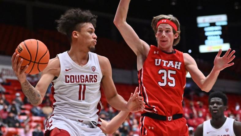 Jan 26, 2022; Pullman, Washington, USA; Washington State Cougars forward D.J. Rodman (11) passes the ball against Utah Utes center Branden Carlson (35) in the second half at Friel Court at Beasley Coliseum. Washington State won 71-54. Mandatory Credit: James Snook-USA TODAY Sports