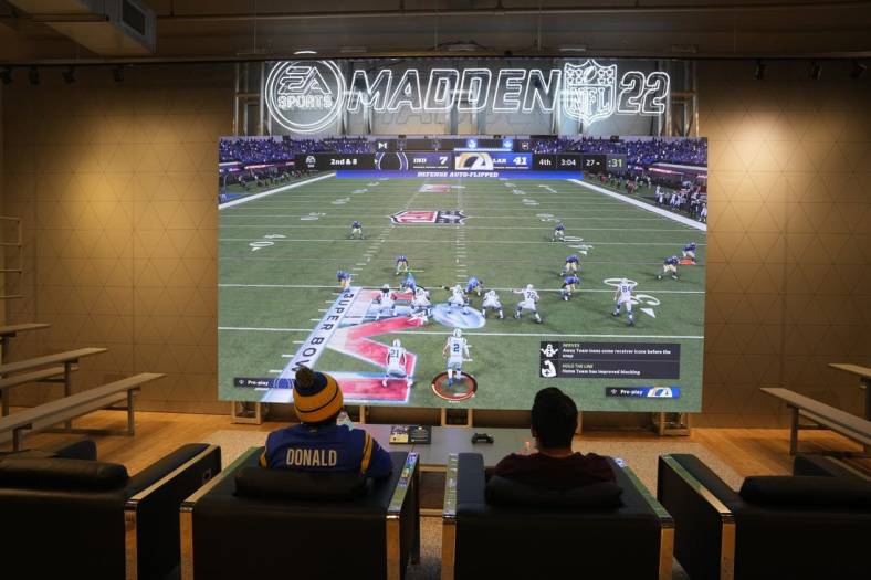 Feb 9, 2022; Los Angeles, CA, USA; People play EA Sports Madden 22 video game at the Nike store at the Grove. Mandatory Credit: Kirby Lee-USA TODAY Sports