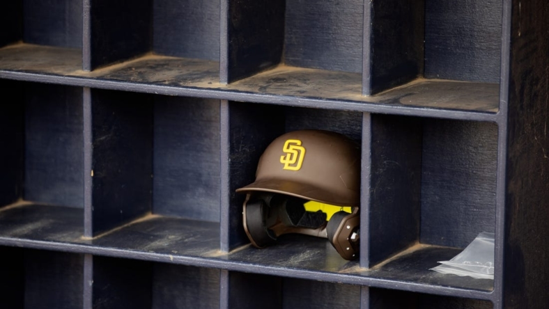 Mar 26, 2022; Peoria, Arizona, USA; Detailed view of a San Diego Padres batting helmet in the dugout against the Chicago Cubs during a spring training game at Peoria Sports Complex. Mandatory Credit: Mark J. Rebilas-USA TODAY Sports