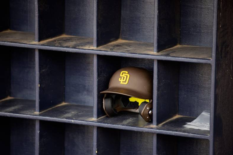 Mar 26, 2022; Peoria, Arizona, USA; Detailed view of a San Diego Padres batting helmet in the dugout against the Chicago Cubs during a spring training game at Peoria Sports Complex. Mandatory Credit: Mark J. Rebilas-USA TODAY Sports