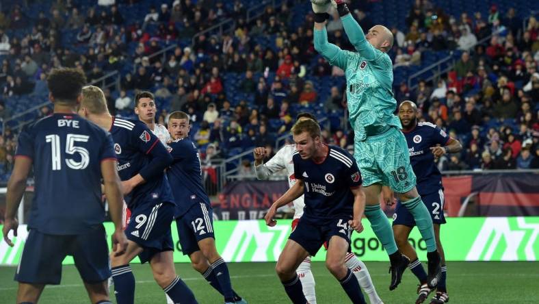 Apr 2, 2022; Foxborough, Massachusetts, USA; New England Revolution goalkeeper Brad Knighton (18) makes a corner kick save during the second half against the New York Red Bulls at Gillette Stadium. Mandatory Credit: Bob DeChiara-USA TODAY Sports