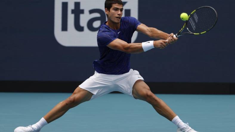 Apr 3, 2022; Miami Gardens, FL, USA; Carlos Alcaraz (ESP) hits a backhand against Casper Ruud (NOR)(not pictured) in the men's singles final in the Miami Open at Hard Rock Stadium. Mandatory Credit: Geoff Burke-USA TODAY Sports