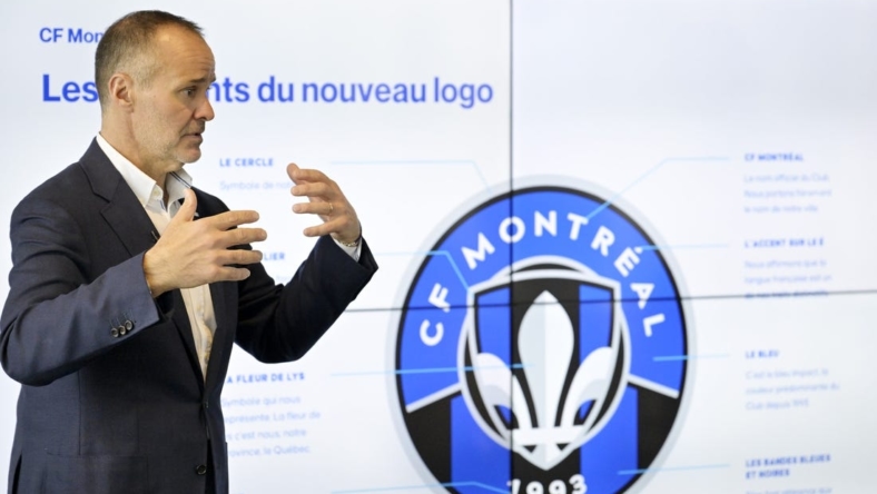May 27, 2022; Montreal, Quebec, Canada; CF Montreal Chairman Joey Saputo with a screen explaining various elements of the new logo during a press conference to introduce the CF Montreal club logo to be used in the 2023 season. Mandatory Credit: Eric Bolte-USA TODAY Sports