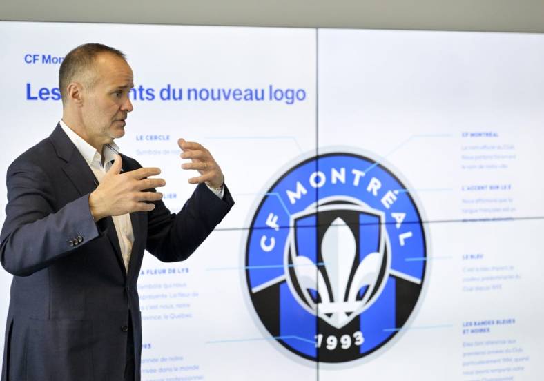 May 27, 2022; Montreal, Quebec, Canada; CF Montreal Chairman Joey Saputo with a screen explaining various elements of the new logo during a press conference to introduce the CF Montreal club logo to be used in the 2023 season. Mandatory Credit: Eric Bolte-USA TODAY Sports