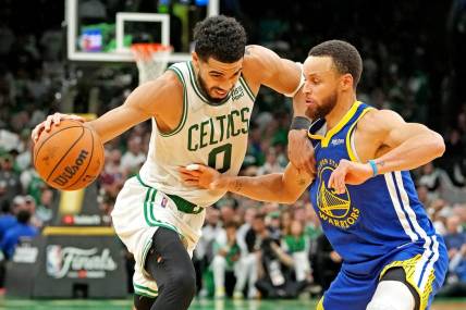 Jun 16, 2022; Boston, Massachusetts, USA; Boston Celtics forward Jayson Tatum (0) handles the ball against Golden State Warriors guard Stephen Curry (30) during the fourth quarter in game six of the 2022 NBA Finals at TD Garden. Mandatory Credit: Kyle Terada-USA TODAY Sports