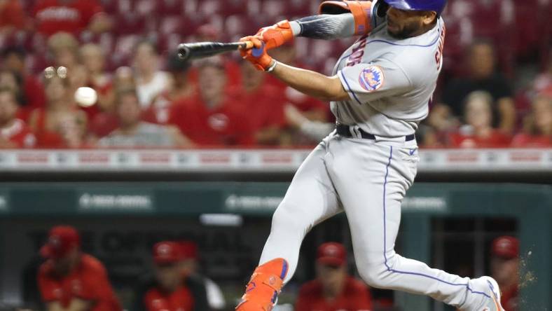 Jul 6, 2022; Cincinnati, Ohio, USA; New York Mets designated hitter Dominic Smith (2) hits an RBI double against the Cincinnati Reds during the tenth inning at Great American Ball Park. Mandatory Credit: David Kohl-USA TODAY Sports