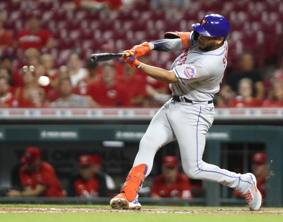 Jul 6, 2022; Cincinnati, Ohio, USA; New York Mets designated hitter Dominic Smith (2) hits an RBI double against the Cincinnati Reds during the tenth inning at Great American Ball Park. Mandatory Credit: David Kohl-USA TODAY Sports