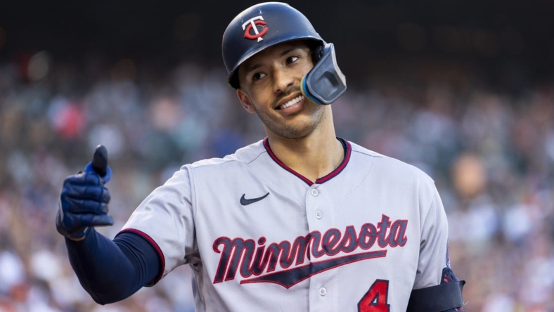 Jul 23, 2022; Detroit, Michigan, USA; Minnesota Twins shortstop Carlos Correa (4) smiles and gives a fan a thumbs up during the seventh inning in a game against the Detroit Tigers at Comerica Park. Mandatory Credit: Raj Mehta-USA TODAY Sports