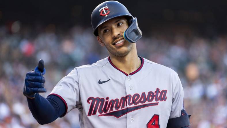 Jul 23, 2022; Detroit, Michigan, USA; Minnesota Twins shortstop Carlos Correa (4) smiles and gives a fan a thumbs up during the seventh inning in a game against the Detroit Tigers at Comerica Park. Mandatory Credit: Raj Mehta-USA TODAY Sports