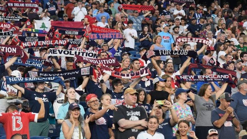 Jul 30, 2022; Foxborough, MA, USA; New England Revolution fans salute the team's entrance for the start of a match against the Toronto FC at Gillette Stadium. Mandatory Credit: Eric Canha-USA TODAY Sports
