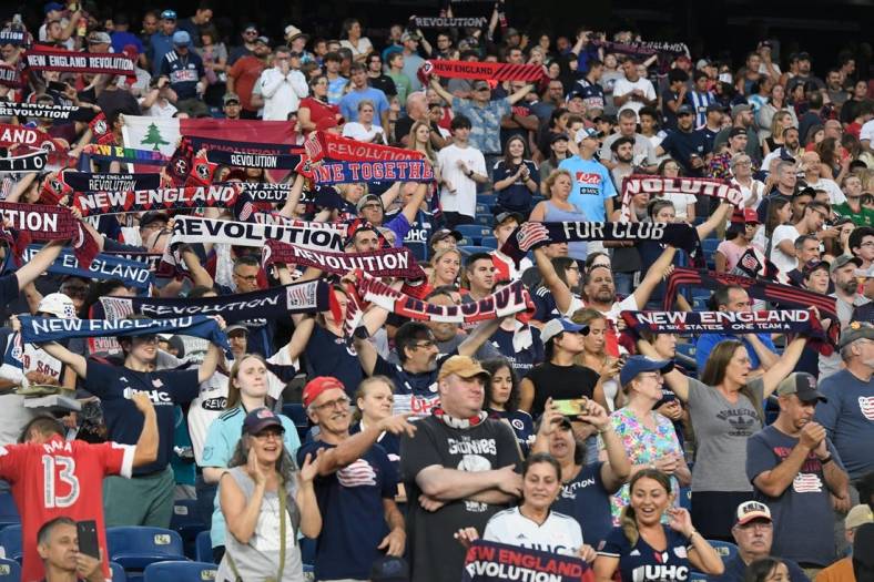 Jul 30, 2022; Foxborough, MA, USA; New England Revolution fans salute the team's entrance for the start of a match against the Toronto FC at Gillette Stadium. Mandatory Credit: Eric Canha-USA TODAY Sports