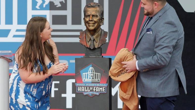 Shannon and Connor O'Hara, the grandchildren of Art McNally's admire their grandfather's bust during the Pro Football Hall of Fame Enshrinement at Tom Benson Stadium in Canton on Saturday, August 6, 2022.

Art Mcnally 0035