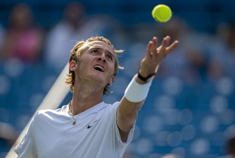 Aug 18, 2022; Cincinnati, OH, USA; Sebastian Korda (USA) tosses the ball to serve during his match against John Isner (USA) at the Western & Southern Open at the at the Lindner Family Tennis Center. Mandatory Credit: Susan Mullane-USA TODAY Sports