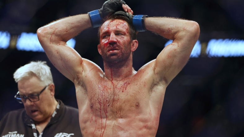 Aug 20, 2022; Salt Lake City, Utah, USA; Luke Rockhold (blue gloves) reacts after being defeated by Paulo Costa (red gloves) during UFC 278 at Vivint Arena. Mandatory Credit: Jeffrey Swinger-USA TODAY Sports