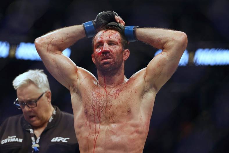 Aug 20, 2022; Salt Lake City, Utah, USA; Luke Rockhold (blue gloves) reacts after being defeated by Paulo Costa (red gloves) during UFC 278 at Vivint Arena. Mandatory Credit: Jeffrey Swinger-USA TODAY Sports