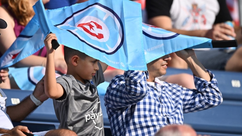 Aug 21, 2022; Chicago, Illinois, USA;  Fans shield themselves from the sun using their Chicago Fire FC flags during the first half of a game against New York City FC at Bridgeview Stadium. Mandatory Credit: Jamie Sabau-USA TODAY Sports